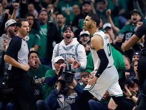 Boston Celtics' Jayson Tatum reacts after scoring during the first quarter of Game 1 of an NBA basketball first-round playoff series against the Milwaukee Bucks, in Boston, Sunday, April 15, 2018.