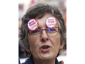 A demonstrator stuck stickers on her glasses reading "My train, I care" during a march by rail workers protesting against French President Emmanuel Macron's government reforms, in Marseille, France, Saturday, April, 2018