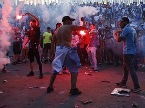 Supporters of Marseille light red flares outside the stadium before the Europa League semifinal first leg soccer match between Olympique Marseille and RB Salzburg in Marseille, France, Thursday, April 26, 2018.