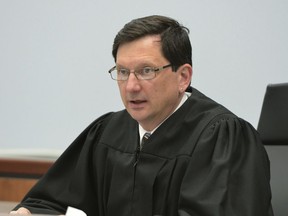 FILE - In this March 21, 2016, file photo, Judge Thomas Estes presides in Eastern Hampshire District Court in Belchertown, Mass. The Commission on Judicial Conduct is asking for Judge Estes to be suspended indefinitely without pay to give lawmakers time to decide whether to remove him from the bench for his relationship with Tammy Cagle, who worked in the special drug court where Estes sat.
