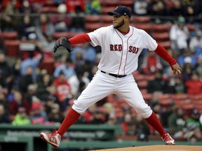 Boston Red Sox's Eduardo Rodriguez winds up for a pitch against the Tampa Bay Rays during the first inning of a baseball game, Sunday, April 8, 2018, in Boston.