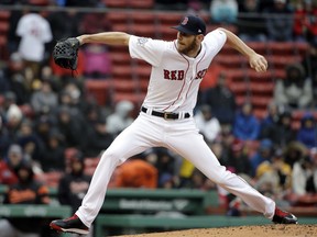 Boston Red Sox's Chris Sale winds up for a pitch against the Baltimore Orioles in the second inning of a baseball game Sunday, April 15, 2018, in Boston.