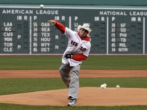 Carlos Arredondo throws out a ceremonial first pitch before a baseball game between the Boston Red Sox and the Baltimore Orioles, Sunday, April 15, 2018, in Boston. Arredondo helped save the life of marathon spectator Jeff Bauman after the 2013 Boston Marathon bombings. He is preparing to run in his first Boston Marathon on April 16, 2018.