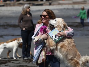 Dog walkers gather to remember former first lady Barbara Bush at Gooch's Beach in Kennebunk, Maine, Sunday, April 22, 2018. The former first lady loved to walk her dogs and chat with the locals during visits to Maine. Barbara Bush died Tuesday at home in Houston at the age of 92.