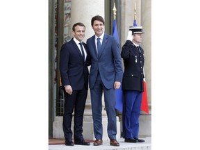 French President Emmanuel Macron, left, welcomes Canadian Prime Minister Justin Trudeau at the Elysee Palace in Paris, Monday, April 16, 2018. Trudeau is on a two days visit to France.