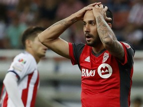 Toronto FC's Victor Vazquez holds his head in disbelief after being called  for a foul during the CONCACAF Champions League final soccer match against Chivas, in Guadalajara, Mexico, on Wednesday night.