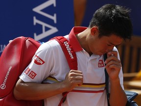 Kei Nishikori of Japan walks off the court as he retires from his match against Guillermo Garcia Lopez during the Barcelona Open Tennis Tournament in Barcelona, Spain, Wednesday, April 25, 2018.