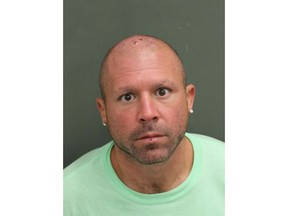 This April 26, 2018 photo made available by the Orange County Sheriff's Office, Fla., shows Rocco Joseph Mantella under arrest. Police arrested Mantella after people at a park in Orlando, Fla., saw him kicking swans in the head. Mantella was arrested on a cruelty to animals charge. (Orange County Sheriff's Office via AP)