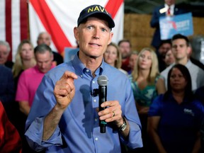 FILE - In this April 9, 2018 file photo Florida Gov. Rick Scott announces his bid to run for the U.S. Senate at a news conference in Orlando, Fla. Confronted with a federal judge's looming deadline, Scott called an extraordinary late-night meeting of top state officials Wednesday, April 25 to decide what to do about the state's process for restoring voting rights to former prisoners.