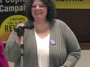 In this March 30, 2018 frame from video provided by the West Virginia Poor People's Campaign, Amy Jo Hutchison speaks during a meeting of the Poor People's Campaign, where she is a chair, in South Charleston, W.Va. She says people perceive her as "solidly middle class" but that she gets government aid for her and her two daughters and she describes herself as living on the "high end of poverty." (West Virginia Poor People's Campaign via AP)