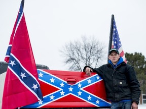 Cameron Meyers poses outside Bay City Western High School with his truck on Wednesday, April 18 2018, in Auburn, Mich. Meyers claims his Confederate flag was torn from his truck last Thursday, April 12, by a fellow Western student and his calls for the administration to discipline that student went unanswered. "They shut me down," Myers said. "They should be punished for destruction of property."