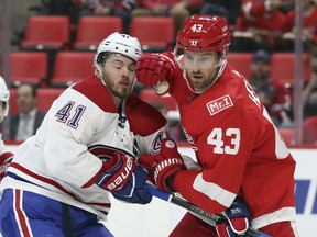 Detroit Red Wings left wing Darren Helm (43) checks Montreal Canadiens left wing Paul Byron (41) during the first period of an NHL hockey game Thursday, April 5, 2018, in Detroit.