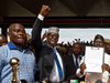 Opposition politician Miguna Miguna raises his fist as opposition leader Raila Odinga holds an oath during a mock "swearing-in" ceremony in Nairobi, Kenya.