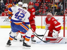 Detroit Red Wings goaltender Jared Coreau (31) stops a New York Islanders defenseman Scott Mayfield (42) shot in the first period of an NHL hockey game Saturday, April 7, 2018, in Detroit.