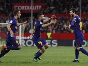 Barcelona's Messi, right, celebrates with teammates after scoring against Sevilla during La Liga soccer match between Barcelona and Sevilla at the Sanchez Pizjuan stadium, in Seville, Spain on Saturday, March 31, 2018.