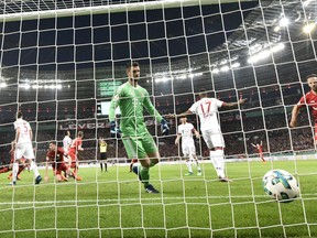 Bayern goalkeeper Sven Ulreich, center, receives a goal by Leverkusen's Lars Bender during the German soccer cup semifinal match between Bayer Leverkusen and Bayern Munich in Leverkusen, Germany, Tuesday, April 17, 2018.