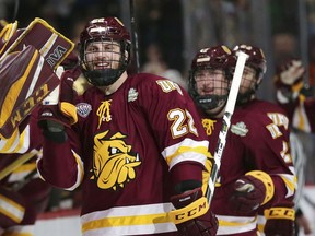 Minnesota Duluth players celebrate a goal by center Jared Thomas (22) against Notre Dame in the first period during an NCAA Frozen Four championship college hockey game, Saturday, April 7, 2018,in St. Paul, Minn..