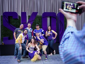 Fans pose for a photo at the Minnesota Vikings' NFL football draft party Thursday, April 26, 2018, in Minneapolis.