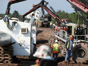 FILE - In this Aug. 21, 2017, file photo, automated welding takes place as sections of the replacement Enbridge Energy Line 3 crude oil pipeline are joined together in Superior, Wis. An administrative law judge is due to recommend whether Minnesota regulators should approve Enbridge Energy's proposal for replacing its aging Line 3 crude oil pipeline across northern Minnesota. The proposal has drawn strong opposition because the line would carry Canadian tar sands crude across environmentally sensitive areas in the Mississippi River headwaters region where American Indians harvest wild rice and hold treaty rights.