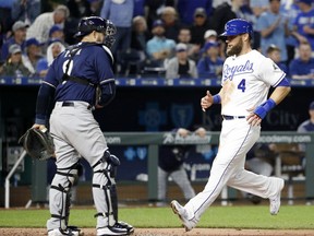 Kansas City Royals' Alex Gordon (4) runs home to score on a sacrifice fly by Alcides Escobar during the fifth inning of a baseball game against the Milwaukee Brewers Tuesday, April 24, 2018, in Kansas City, Mo.