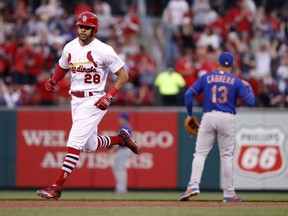 St. Louis Cardinals' Tommy Pham (28) rounds the bases past New York Mets shortstop Asdrubal Cabrera (13) after hitting a two-run home run during the first inning of a baseball game Tuesday, April 24, 2018, in St. Louis.