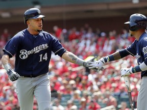Milwaukee Brewers' Hernan Perez (14) is congratulated by teammate Orlando Arcia after hitting a solo home run during the second inning of a baseball game against the St. Louis Cardinals Wednesday, April 11, 2018, in St. Louis.