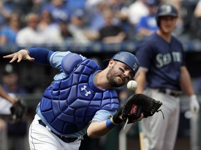 Kansas City Royals catcher Cam Gallagher drops a foul ball hit by Seattle Mariners' Kyle Seager during the first inning of a baseball game at Kauffman Stadium in Kansas City, Mo., Wednesday, April 11, 2018.