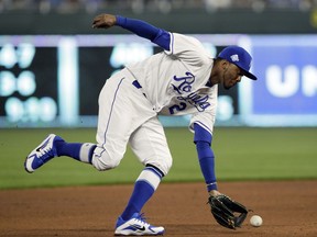 Kansas City Royals shortstop Alcides Escobar fields a ground ball hit by Seattle Mariners' Jean Segura during the fourth inning of a baseball game at Kauffman Stadium in Kansas City, Mo., Tuesday, April 10, 2018. Segura was safe at first base on the play.
