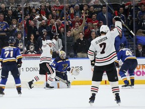 Chicago Blackhawks left wing Brandon Saad, second from left, reacts after teammate Duncan Keith scored in the final seconds of an NHL hockey game against the St. Louis Blues on Wednesday, April 4, 2018, in St. Louis.