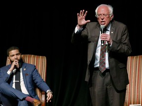 In this April 4, 2018 photo, Jackson Mayor Chokwe Antar Lumumba, left, listens as Sen. Bernie Sanders, I-Vt., answers a question during a town hall meeting examining economic justice 50 years after the assassination of Dr. Martin Luther King Jr., in Jackson, Miss.