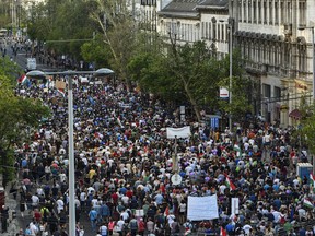 Thousands of people march during a protest in in Budapest, Hungary, Saturday, April 21, 2018. Tens of thousands are taking part in a rally against the distorting media policies of Prime Minister Viktor Orban's government and its campaign against civic groups it considers are illegitimately trying to influence political decisions.
