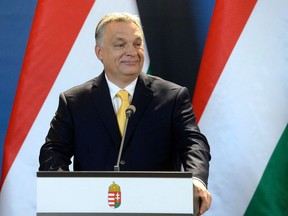 Hungarian Prime Minister Viktor Orban smiles during an international press conference in the Parliament building in Budapest, Hungary Tuesday, April 10, 2018, two days after his Fidesz party in coalition with the Christian Democratic Party won a landslide vitory in the general elections.
