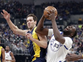 Golden State Warriors forward Draymond Green (23) is fouled by Indiana Pacers forward Bojan Bogdanovic (44) during the first half of an NBA basketball game in Indianapolis, Thursday, April 5, 2018.