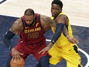 Indiana Pacers guard Victor Oladipo (4) defends against Cleveland Cavaliers forward LeBron James (23) during the second half of Game 3 of an NBA basketball first-round playoff series in Indianapolis, Friday, April 20, 2018.