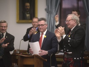 Prince Edward Island Premier Wade MacLauchlan applauds alongside Liberal Finance Minister Heath MacDonald during the release of the provincial budget in Charlottetown, P.E.I., Friday, April 6, 2018.