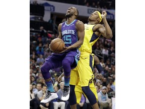 Charlotte Hornets' Kemba Walker (15) is fouled as he drives past Indiana Pacers' Myles Turner during the first half of an NBA basketball game in Charlotte, N.C., Sunday, April 8, 2018.