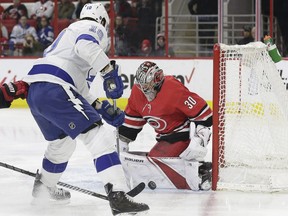 Tampa Bay Lightning's J.T. Miller (10) is blocked by Carolina Hurricanes goalie Cam Ward (30) during the first period of an NHL hockey game in Raleigh, N.C., Saturday, April 7, 2018.