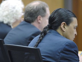 Chase Iron Eyes, right, sits next to his attorneys in a Morton County courtroom in Mandan, N. D., Wednesday, April 4, 2018, during a pretrial conference on charges of felony inciting a riot and misdemeanor criminal trespass related to the Dakota Access Pipeline protests on Feb. 1, 2017.