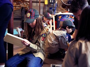 In a Thursday, March 1, 2018 photo, Tatum Weir, left, sets to drill a pilot hole while building a tool box during a cub scout meeting in Madbury, N.H. Fifteen communities in New Hampshire are part of an "early adopter" program to allow girls to become Cub Scouts and eventually Boy Scouts. Tatum and her twin brother Ian are planning to become the first set of girl-boy siblings to become Eagle Scouts.
