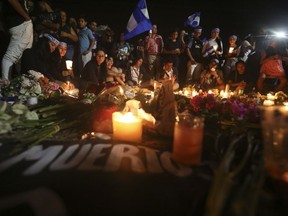 Demonstrators hold a candlelight vigil in honor of those who have died during anti-government protests in Managua, Nicaragua, Wednesday, April 25, 2018. On Sunday, President Daniel Ortega backed off a social security overhaul that triggered protests, during which at least 30 people have died according to human rights groups.