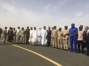 U.S Ambassador to Niger, Eric P. Whitaker, centre, and Niger's Minister of Defense Kalla Moutari, stand with other government officials for a photograph during an open annual counter-terror exercise in Niamey, Niger, Wednesday, April 11, 2018. Six months after the deaths of U.S. soldiers in Niger led to questions about the military's presence in the West African nation, the U.S. special operations command in Africa on Wednesday opened its annual counter-terror exercise in the face of a growing extremist threat.