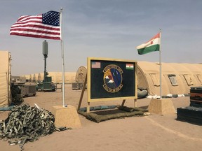 In this photo taken Monday, April 16, 2018, a U.S. and Niger flag are raised side by side at the base camp for air forces and other personnel supporting the construction of Niger Air Base 201 in Agadez, Niger. On the scorching edge of the Sahara Desert, the U.S. Air Force is building a base for armed drones, the newest front in America's battle against the growing extremist threat in Africa's vast Sahel region. Three hangars and the first layers of a runway command a sandy, barren field. Niger Air Base 201 is expected to be functional early next year.