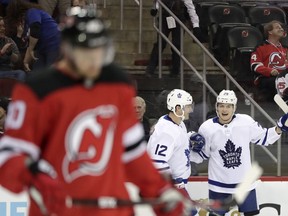 New Jersey Devils right wing Michael Grabner, left, of Austria, skates away as Toronto Maple Leafs center William Nylander, right, celebrates his goal with teammate Patrick Marleau during the first period of an NHL hockey game, Thursday, April 5, 2018, in Newark, N.J.