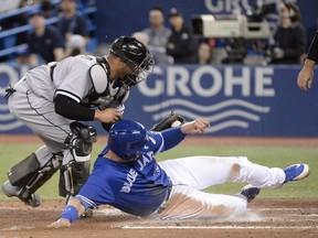 Chicago White Sox catcher Welington Castillo (21) tags out Toronto Blue Jays first baseman Justin Smoak (14) at home plate during sixth inning American League baseball action in Toronto on Wednesday, April 4, 2018.