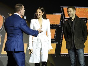 John Cena, left, and Hailee Steinfeld, center, cast members in the upcoming film "Bumblebee," share the stage with director Travis Knight during the Paramount Pictures presentation at CinemaCon 2018, the official convention of the National Association of Theatre Owners, at Caesars Palace on Wednesday, April 25, 2018, in Las Vegas.