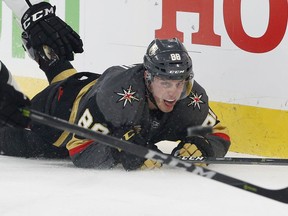 Vegas Golden Knights defenseman Nate Schmidt is knocked to the ice during the first period of Game 1 of the team's NHL hockey first-round playoff series against the Los Angeles Kings, Wednesday, April 11, 2018, in Las Vegas.