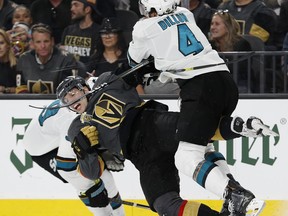 San Jose Sharks defenseman Brenden Dillon (4) checks Vegas Golden Knights left wing David Perron during the second period of Game 1 of an NHL hockey second-round playoff series, Thursday, April 26, 2018, in Las Vegas.