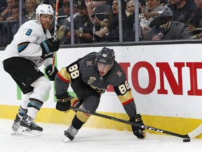 Vegas Golden Knights defenseman Nate Schmidt (88) vies for the puck in front of San Jose Sharks center Joe Pavelski (8) during the third period of Game 1 of an NHL hockey second-round playoff series, Thursday, April 26, 2018, in Las Vegas. The Golden Knights won 7-0.