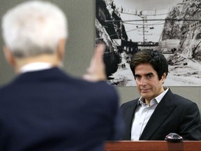 David Copperfield looks at attorney Benedict Morelli as he takes questions during his civil trial at the Regional Justice Center on Tuesday, April 24, 2018, in Las Vegas. A British tourist claims he was seriously hurt in a fall while taking part in one of Copperfield's signature illusions in 2013. Plaintiff Gavin Cox of Kent, England, alleges he fell after being hurried by stagehands through an MGM Grand hotel alleyway coated with a powdery residue near a trailer-sized trash bin.