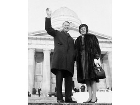 FILE - In this Jan. 17, 1963 file photo, Philip H. Hoff and wife Joan wave in front of the Vermont State House as he became the first democratic governor in over 100 years in Montpelier, Vt.  Hoff, who's credited with starting Vermont's transition from one of the most Republican-entrenched states in the country to one of the most liberal, died on Thursday, April 26, 2018, according to The Residence at Shelburne Bay, where he had been living.(AP Photo, File)